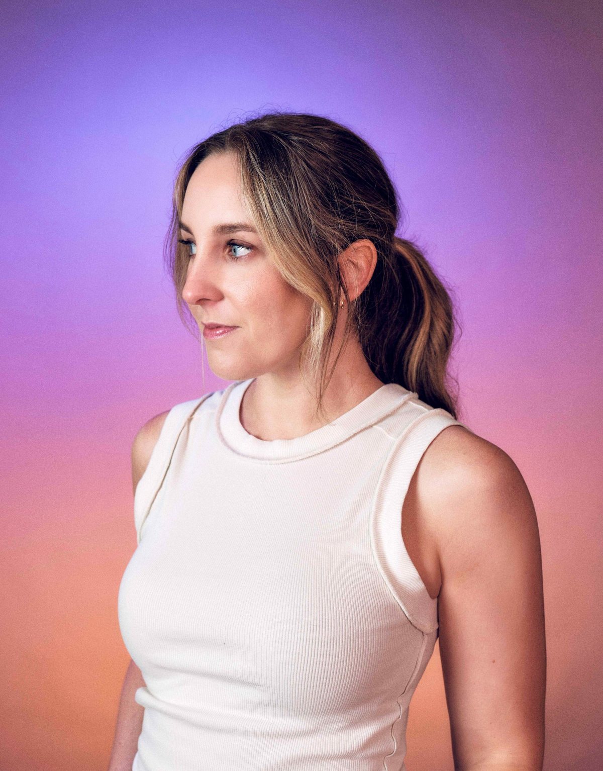 Portrait of Lindsay Rife against a violet to peach gradient